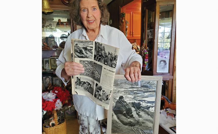 Photos by Stacy Van Buskirk/svanbuskirk@cherokeescout.com  Mary Ann Thompson, sister to Andrew Gaddis, holds the original Life magazine issue featuring his photo and a larger copy of the photo sent to the family. Gaddis was killed in action in 1951, leaving behind several medals in his all-too- brief military career 