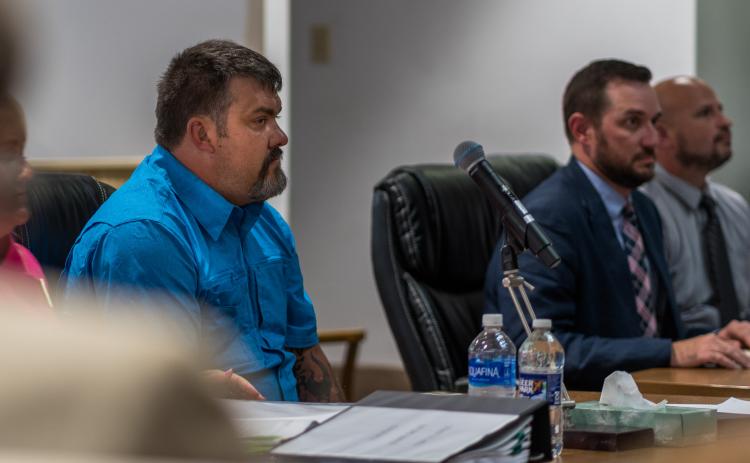From left, Christopher Drew Hill listens to testimony in court alongside assistant district attorney Caleb Decker and Graham County sheriff’s Deputy Matt Cox. 