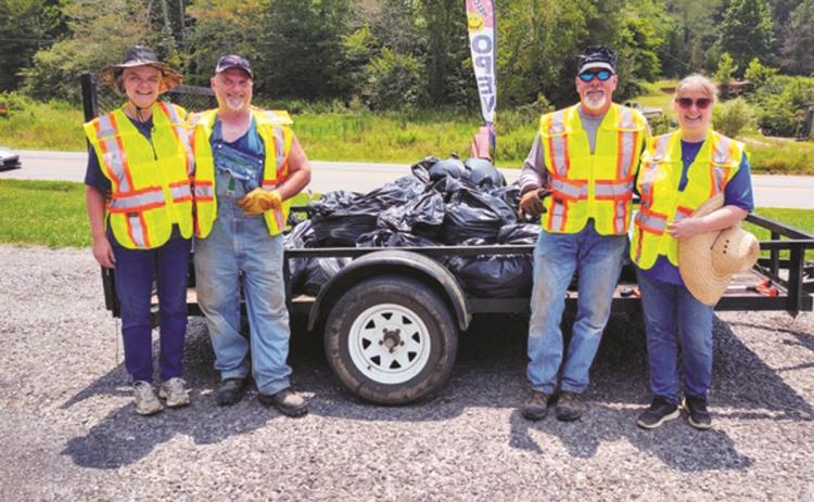 After five hours of cleaning up trash, a four-member team collected more than 30 bags of trash weighing about 750 pounds. Shown are (from left) Patty Freeman, Ronney Freeman, Jeff Thomason and Dee Dee Deal of Turtletown who came together July 24 to pick up trash along Runion Road.