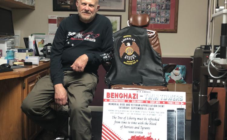 Dr. Dan Eichenbaum with his memorial sign and riding clothes.