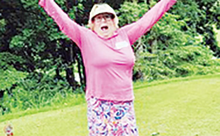 Susan Carmichael celebrates after making a hole-in-one on No. 17.