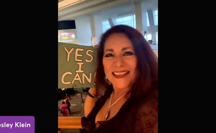 Lesley Klein holds up her inspirational sign at the Atlanta auditions for the Great American Speak Off show.