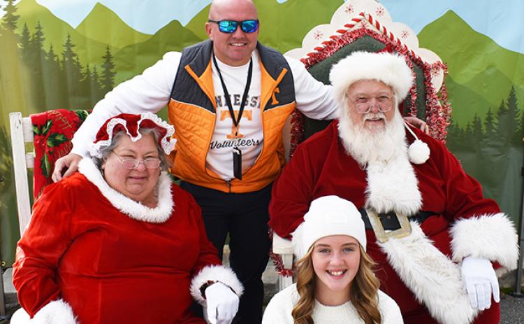 Andrews Police Chief Rocky Burrell and daughter Trista visited Santa and Mrs. Claus on Saturday afternoon during Christmas on Main Street. The event went so well that law enforcement could have a good time, too. 