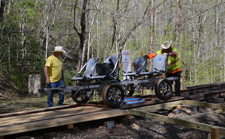Abigail Blythe Batton/Staff Correspondent   Flagman Jack Roberson and engineer Rick Lapolla get the rail bikes into position at the turnaround in the Valley River Tunnel. See the video on cherokeescout.com.