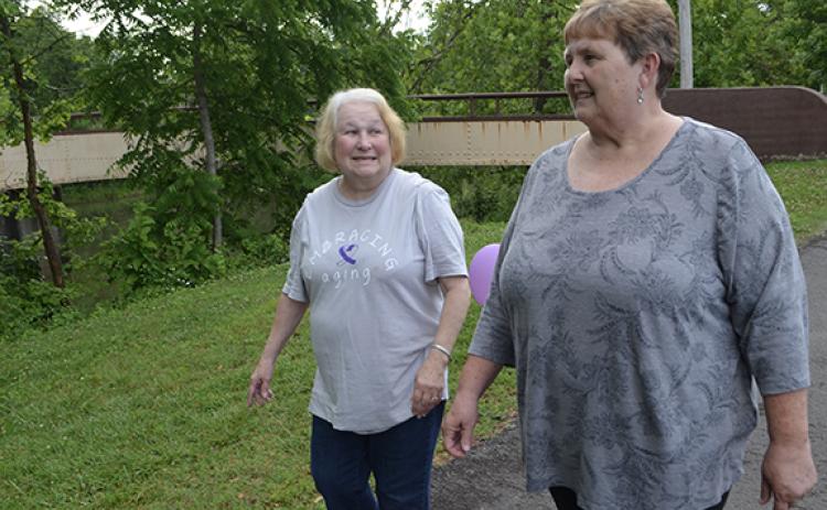 Abigail Blythe Batton/Staff Correspondent Joy Dockery and her best friend of 30 years, Cathy Huskins, came out to support Elder Abuse Awareness Day on Thursday night at the pavilion on Connahetta Street in Murphy. Dockery, who has walked for three years, said, “I don’t want to see the elders mistreated.”