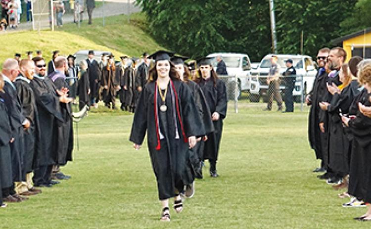Photos by Randy Foster/editor@cherokeescout.com Graduating seniors, cheered on by Murphy High School’s faculty and staff, make their way onto David Gentry Field at Bob Hendrix Stadium during Friday night’s commencement.