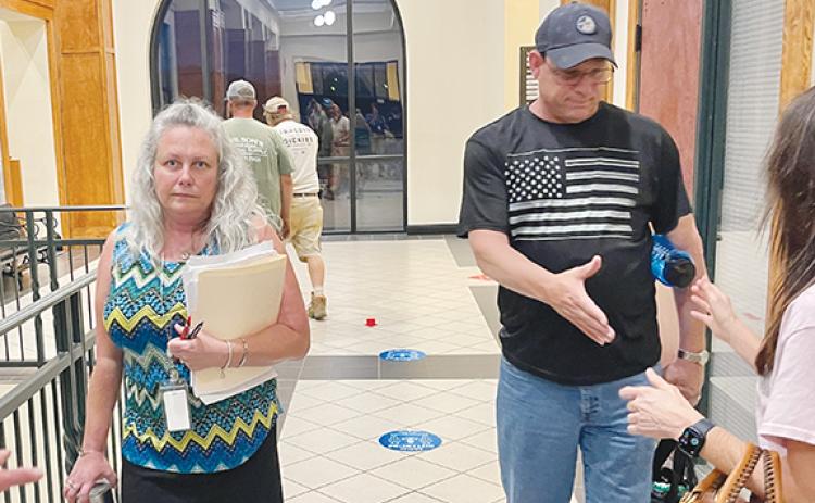 Randy Foster/editor@cherokeescout.com Teresa Ricks, with her husband David Ricks, greet well-wishers following a June 5 decision by the Cherokee County Board of Commissioners to keep her on as the county’s tax assessor.