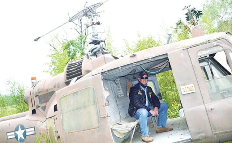 Abigail Blythe Batton/Staff Correspondent Dave “Scout” Nelson sits in the back of a UH-1 Iroquois helicopter at Roger Swanson’s Band of Brothers Veterans Park in Murphy.
