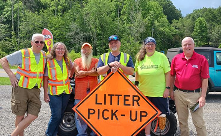 From left are Mike and Karen Herring, Frankie Womble, Ronney Freeman Sr., Michelle Degner and William Wallace, Polk County’s litter grant director.