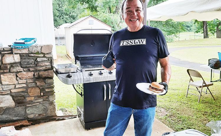 Anngee Quinones-Belian/ Staff Correspondent  Well-known James “Bo” Taylor, a Cherokee dancer and storyteller, was also busy grilling burgers and hot dogs during the health fair at the Marble Community Center on Thursday.