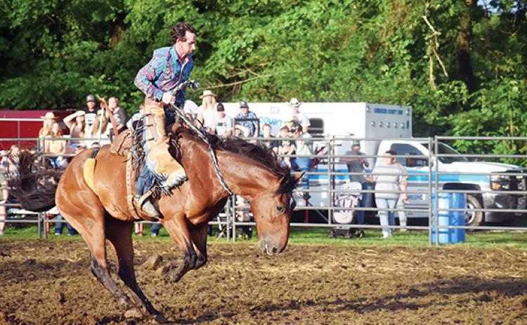 Photos by Justin Fitzgerald/sports@cherokeescout.com Matt Seymour tries to stay on his horse during the Ranch Bronco event at the Great American Rodeo Company rodeo in Andrews on Saturday night;