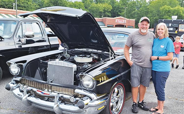 Photos by Bill Belian/Contributing Photographer Scott and Angie Dockery won a trophy for “Top 15” with their 1957 Chevy Bel Air. Happy to be at the Hot Summer Nights Cruise-in under rainy skies in Andrews, Scott said, “It takes five hours to wash, dry and shine it, but we’re happy to help the veterans.”