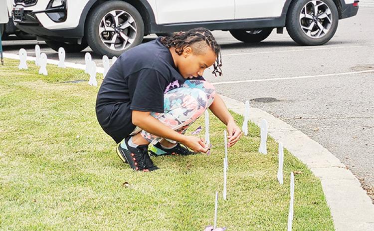 Local residents fighting back place memorials to victims of domestic violence at First United Methodist Church in downtown Murphy on Friday.