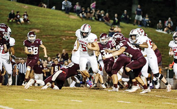 Haley West/Contributing Photographer Andrews’ Dalton Rose tries to run past several Swain County defenders during the Wildcats’ 20-0 loss at the Maroon Devils on Friday night.