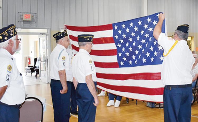 American Legion Post 96 of Murphy prepares to fold a U.S. flag, which will be presented to Myers in a display case at a later date.