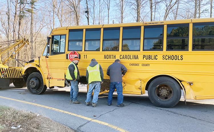 Randy Foster/editor@cherokeescout.com Maintenance workers from Cherokee County Schools prepare a school bus to be towed from a crash scene just off of U.S. 64 West in Ranger on Monday afternoon.