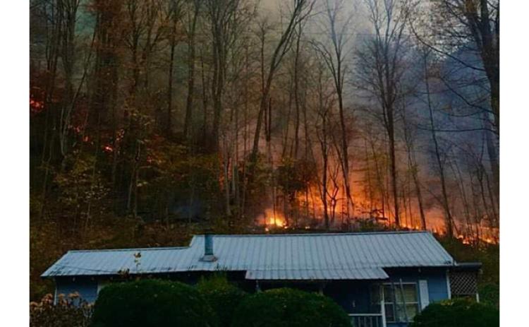 Robbi Pounds/ Contributing Photographer A back fire burns close to housing in Junaluska, but firefighters were on scene.