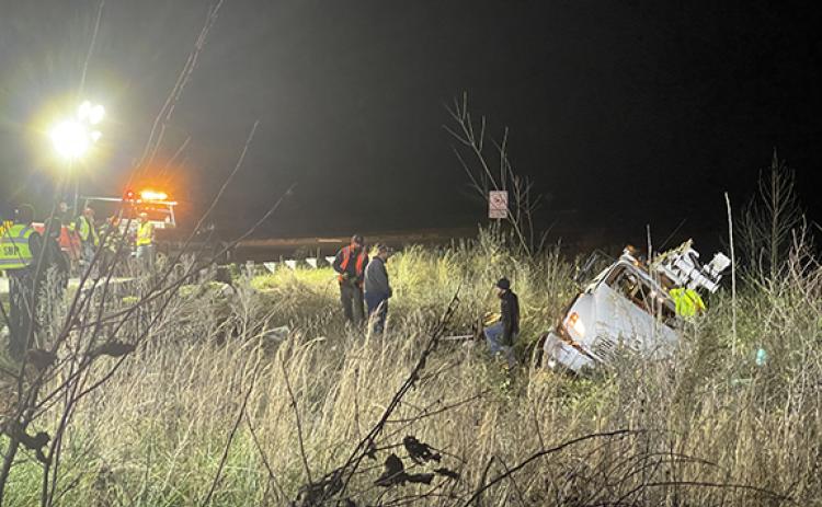 Randy Foster/editor@cherokeescout.com Workers prepare to remove wreckage of a utility pole truck involved in a two-vehicle collision at the entrance to the Cherokee County solid waste disposal site on Monday evening. Eastbound lanes were blocked and traffic was detoured during the recovery operation.