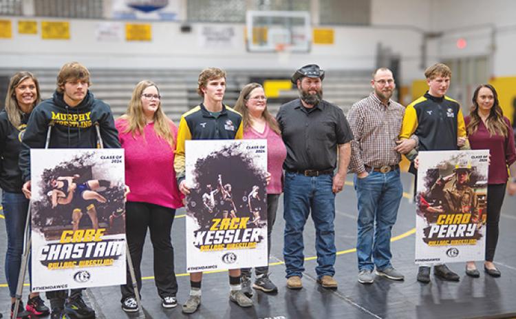 Sam Jokich/Staff Correspondent Murphy wrestlers Gabe Chastain, Zack Kessler and Chad Perry (from left, with their parents) were honored Friday during Senior Night.