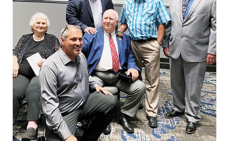 Longtime Swain County coach Boyce Dietz (sitting in middle) celebrates with his sister – along with Murphy coaches James Shope, Eric Brinke, Gary Thompson and Rick Hinke – during his N.C. High School Athletic Association Hall of Fame induction on Aug. 19, 2023.