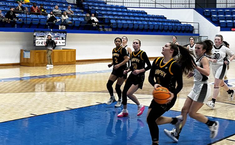 J.R. Carroll/Staff Correspondent. The Murphy girls basketball teams head downcourt during a fast break earlier this season.