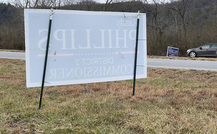 Cherokee County Commissioner Randy Phillips’ campaign signs placed in the right-of-way on both sides of U.S. 19/74/129 near Western Carolina Regional Airport appear to violate state law, which allows placement of campaign signs no sooner than 30 days before one-stop voting begins on Feb. 15.