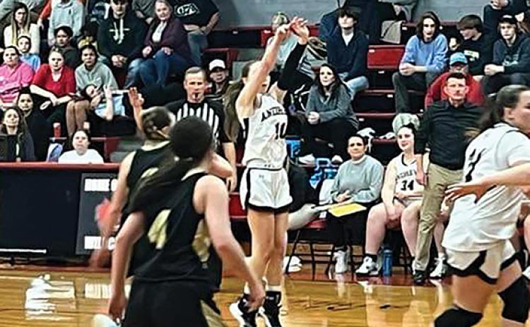 Jeff Tathum/Contributing Photographer Kylie Donaldson takes a shot for the Lady Wildcats.