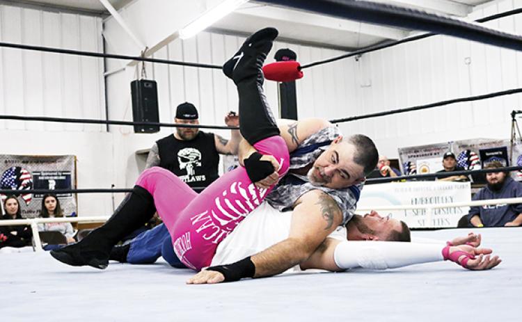Cannon Crompton/sports@cherokeescout.com Mountain Man Jeremy Stiles pins Axel Gunn in the opening match of ACWF Valentine’s Massacre on Saturday night at the Peachtree Community Center.