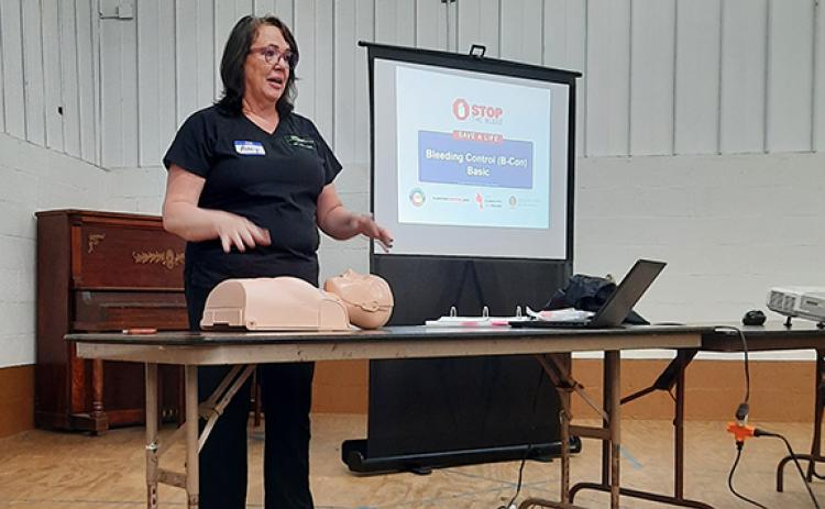 Photos by Anngee Quinones-Belian/Staff Correspondent  Instructor Amy Nance Nelson, a registered nurse, taught folks CPR and techniques on how to stop serious bleeding at the Peachtree Community Center on Saturday morning.
