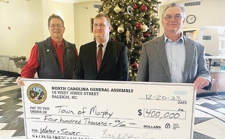 Big time: From left, N.C. Sen. Kevin Corbin (R-Franklin), Murphy Mayor Tim Radford and state Rep. Karl Gillespie (R-Franklin) show off a $400,000 check to the town. The money will be used on the ongoing project to repair and replace Murphy’s aging water line.