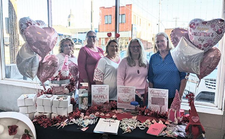 Reach of Cherokee-Graham County set up at Downtown Pizza in Murphy on Valentine’s Day to raise money for items not covered by grants and provide a friendly place to go during the holiday for anyone in an abusive relationship. From left are Lisa Stiles, shelter manager; Debra Mull, advocate; Amanda Hamby, WRC coordinator/court advocate; Alison Carpenter, Graham County advocate; and Judy Jackson, shelter supervisor.