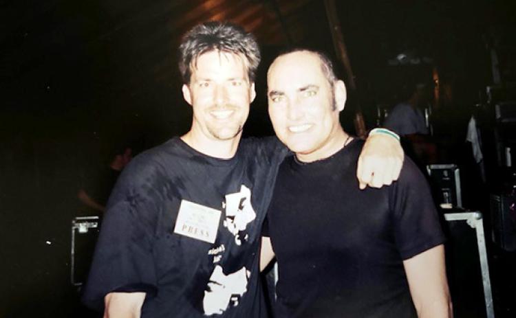 Michael Knott (right) hanging out with a newspaper publisher backstage at the Cornerstone Music Festival in 2002.