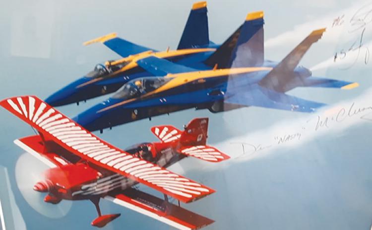Photos by Anngee Quinones-Belian/Staff Correspondent  Displayed on a wall in Dan McClung’s shop are photos of the red-and-white aircraft he built and flew during air shows. His skills earned him the company of the Blue Angels.