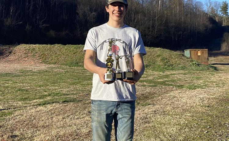 Wendy Parker/Contributing Photographer Andrews High School junior Boone Parker holding his trophy from the Far West Shootout on Saturday, March 2 after shooting a nearly perfect 598/600.