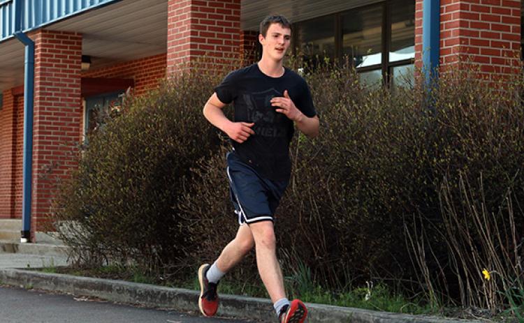 Cannon Crompton/sports@cherokeescout.com Hiwassee Dam’s Travis Allen works on distance running at practice on March 12.