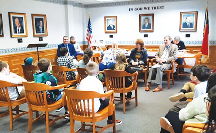 Photos by Anngee Quinones-Belian/Staff Correspondent  Nancy Helms of Ogreeta reads the book Beemer’s Adventures by author Jane Hembree of Murphy to a group of third-grade students from Peachtree Elementary School at Murphy City Hall on Thursday.