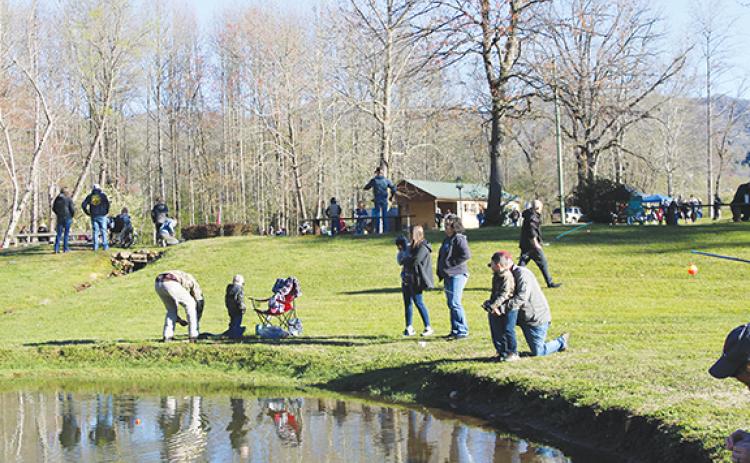 Photos by J.R. Carroll/Staff Correspondent Top: Almost 300 people attended the Kids Fishing Day on Saturday at the Cherokee County Sheriff’s Ranch in Marble. 
