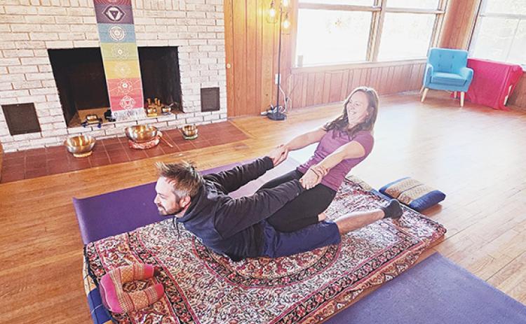 Nicole Wright/Staff Correspondent Massage therapist Renee Lamance and her husband, Zach Kilmer, practice stretching exercises as a form of therapy.