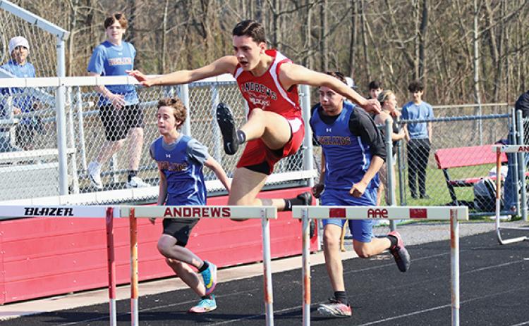 Cannon Crompton/sports@cherokeescout.com Andrews’ Jesus Jimenez jumps a hurdle during a home meet on March 20.