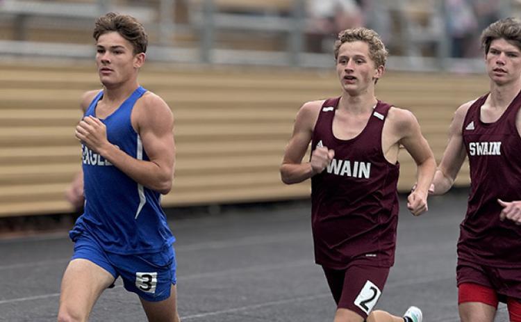 J.R. Carroll/Staff Correspondent Hiwassee Dam’s Ethan Russell (left) tries to hold off two Swain County runners during the Hayesville meet on April 17. 