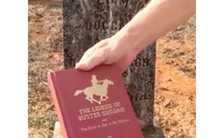 Buster Duggan’s exploits are documented in a book The Legend of Buster Duggan, co-authored by the nephew of John Moses, one of Duggan’s victims. The book is being held in front of Duggan’s tombstone in Monroe County.