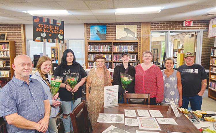 Nicole Wright/Staff Correspondent  From left are staff member Jeff Murphy; Greta Whisonant, artist; Bailey Shope, artist; branch co-manager Kelly Bryant; Jacob Teasdale, artist; branch co-manager Jacqueline Hulse; and Friends of the Andrews Public Library members Barbara El-Khouri and Clifford Panter.